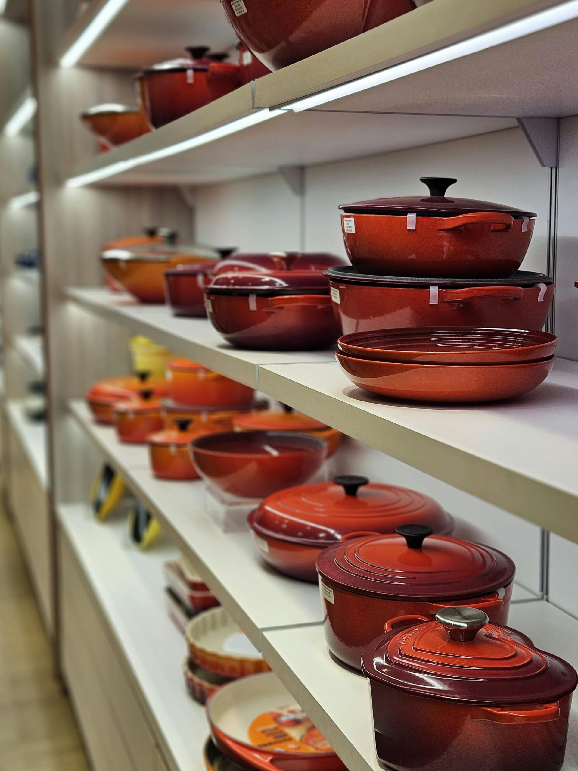 A shop display of various porcelain enamelled pots and pans.